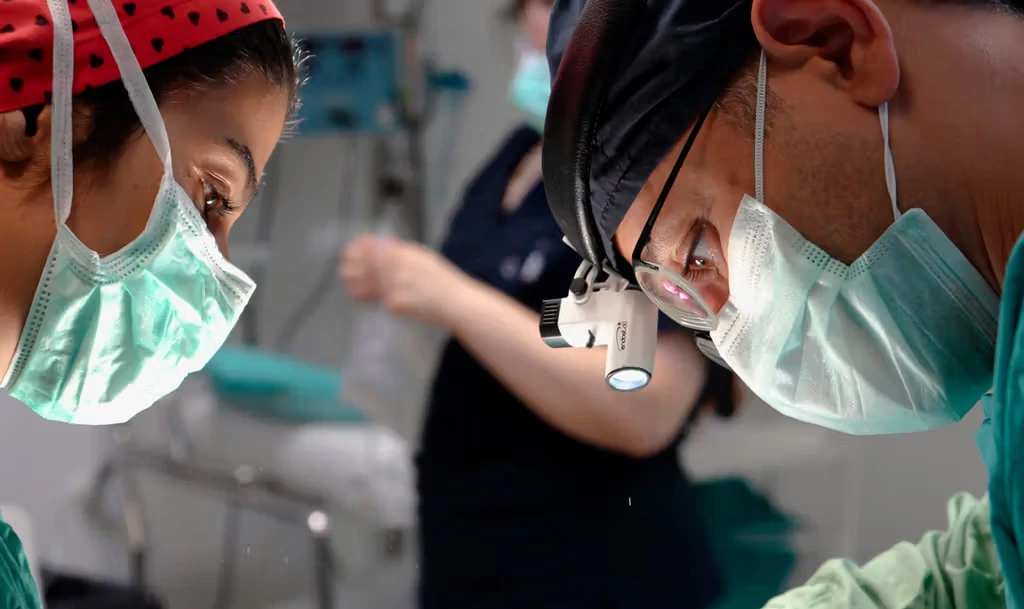 Closeup of two surgeons operating