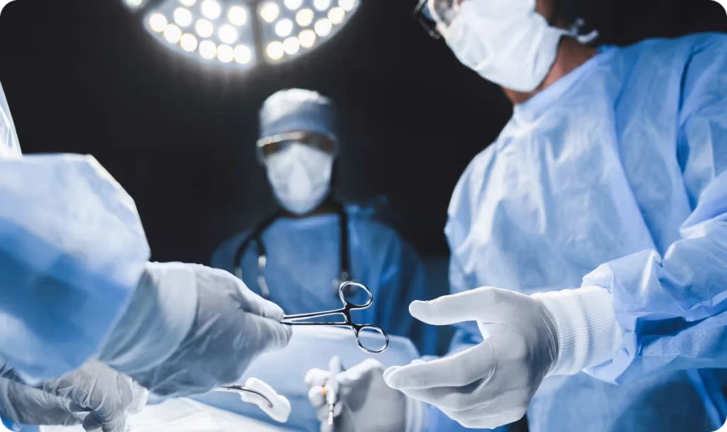surgeon during operation being handed tools