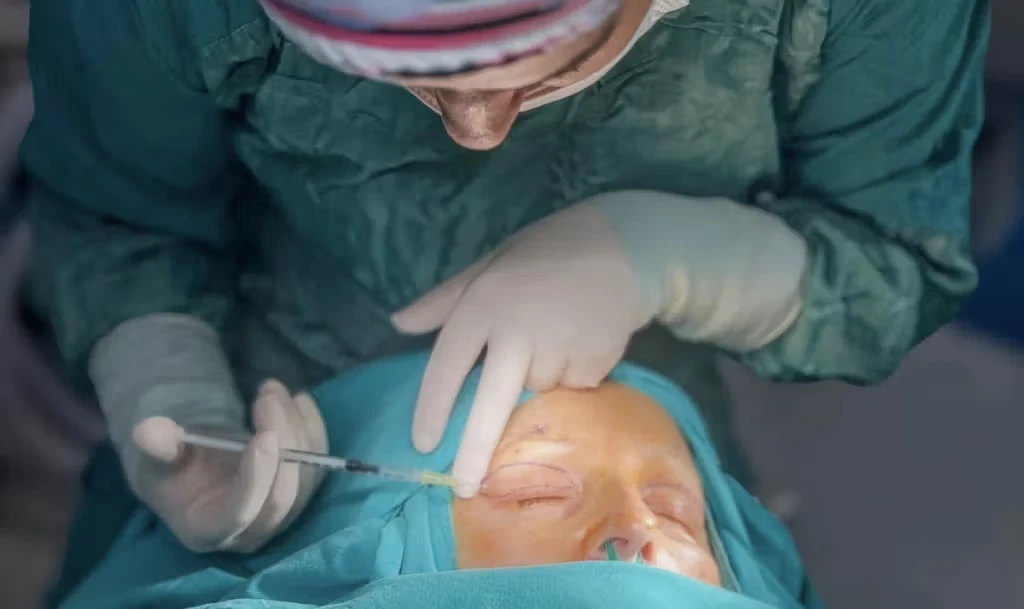overhead shot of doctor performing eyelid surgery
