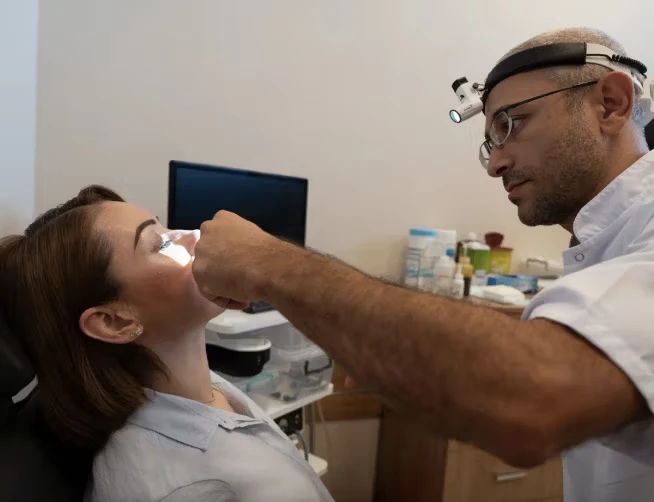 Doctor looking up patient's nose