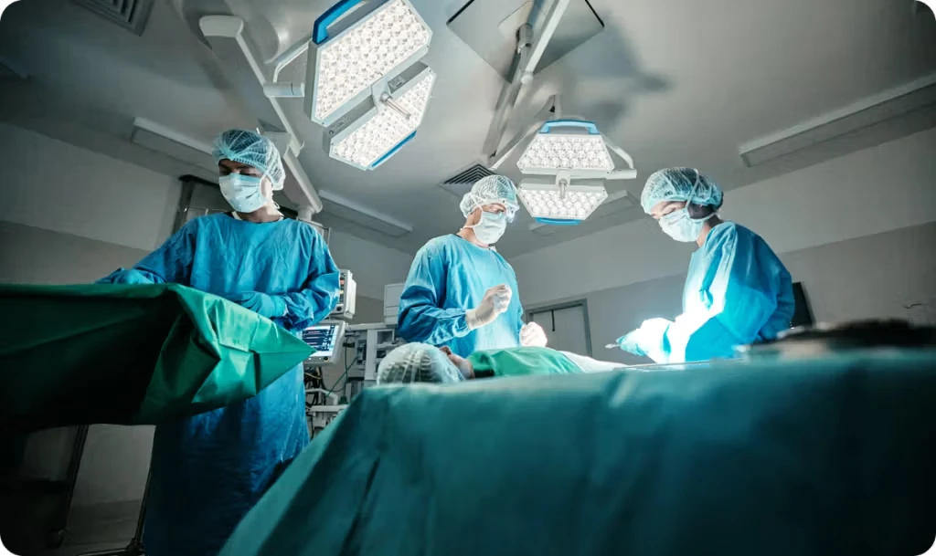 three masked surgeons performing surgery