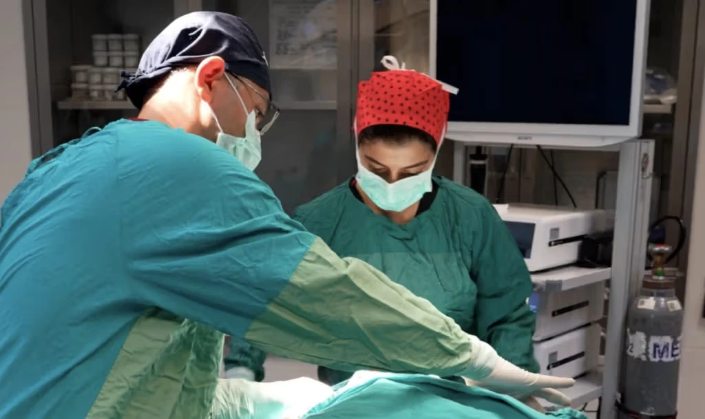 Male and female surgeon operating